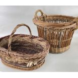 TWO TRADITIONAL WICKER BASKETS, one a circular log bin, 57cm diam., the other and oval basket,