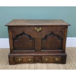 WELSH JOINED OAK COFFER BACH, moulded outer hinged top, pinted arch paneled front, canted angles,