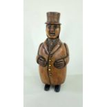19TH CENTURY COQUILLA NUT FIGURAL SNUFFBOX, Dutch/German, standing in frock coat and top