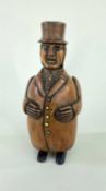 19TH CENTURY COQUILLA NUT FIGURAL SNUFFBOX, Dutch/German, standing in frock coat and top