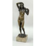 MARCEL KLEINE (German, fl. 1930s) bronze - standing female nude fixing flower garland in her hair,