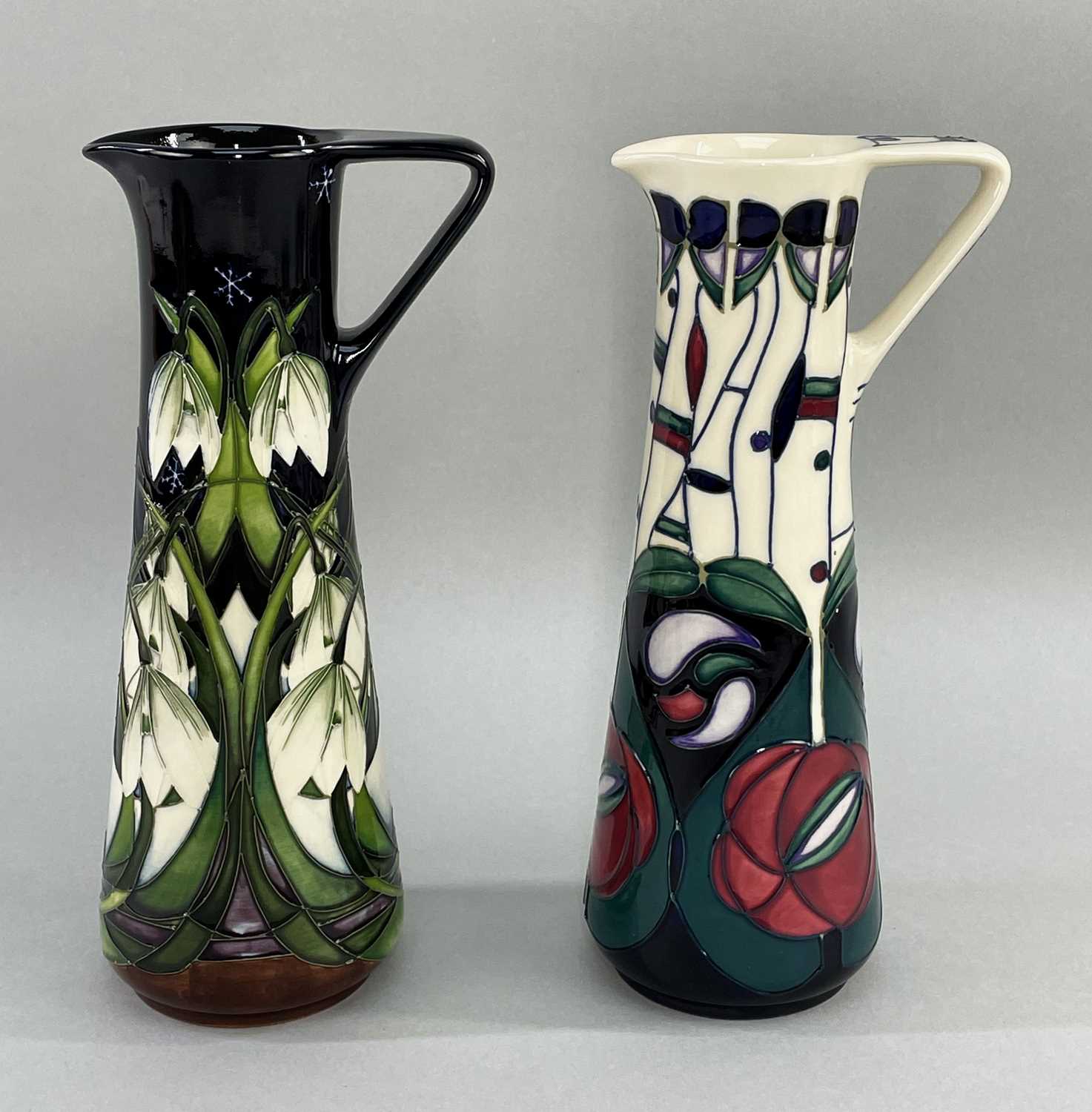 TWO MOORCROFT POTTERY EWERS / JUGS comprising Moorcroft pottery slender ewer in tribute to Charles