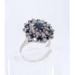 SAPPHIRE & DIAMOND CLUSTER RING, central oval stone appr. 7x5mm, within two registers of 20