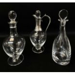 THREE CONTEMPORARY GLASS DECANTERS, the claret decanter and baluster decanter with silver mounts