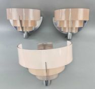 ART DECO CINEMA LIGHTING, historic set of three chrome and frosted pink lobby wall lights, from