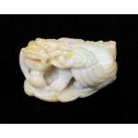 CHINESE JADEITE CARVING OF A BIXIE, recumbent on a leaf holding a lingzi stem in its mouth, base