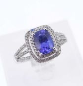 14K WHITE GOLD TANZANITE & DIAMOND RING, the central tanzanite (7 x 6mms approx.) within a double