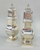 TWO SIMILAR SILVER PIERCED CASTERS, of square design raised on pedestal bases, London & Birmingham