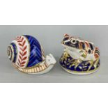 TWO ROYAL CROWN DERBY PAPERWEIGHTS, bone china, in the form of an Imari frog and snail, printed
