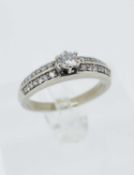 14K GOLD DIAMOND RING, the central stone measuring 0.2cts approx., set with a further 28 graduated