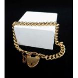 YELLOW GOLD CURB LINK BRACELET, having heart shaped padlock with engraved initials and marked '