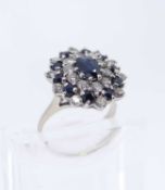 SAPPHIRE & DIAMOND CLUSTER RING, central oval stone appr. 7x5mm, within two registers of 20