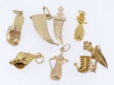 SIX VARIOUS YELLOW METAL CHARMS comprising yellow gold Jambiya dagger charm stamped '750', yellow