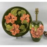 MOORCROFT POTTERY 'HIBISCUS' PATTERN ITEMS comprising table lamp, 30cms high, and platter, paper