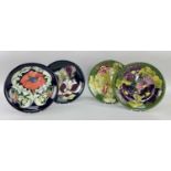 FOUR MOORCROFT POTTERY PLATES, all with tube-line decoration comprising 'Columbine', 'Magnolia', '