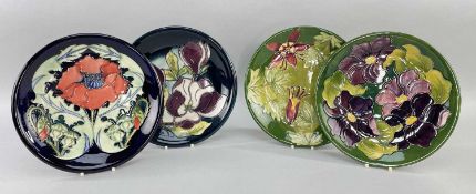 FOUR MOORCROFT POTTERY PLATES, all with tube-line decoration comprising 'Columbine', 'Magnolia', '