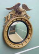 REGENCY-STYLE GILTWOOD & GESSO CONVEX MIRROR with eagle and acanthus surmount, 92 cms