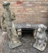 THREE VARIOUS COMPOSITION STONE GARDEN ORNAMENTS, including a curved seat bench, 128cms wide, seated