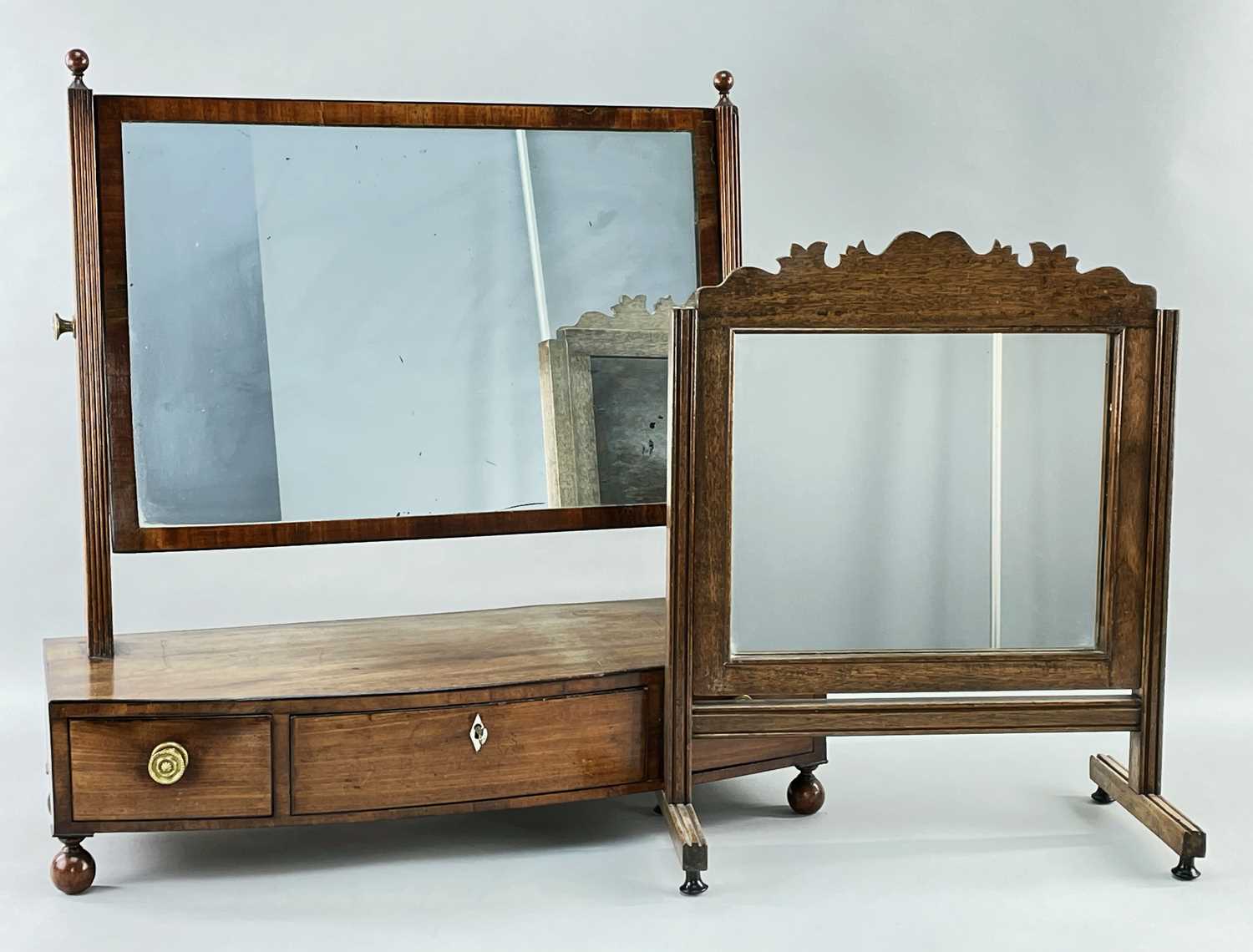 TWO MAHOGANY DRESSING TABLE MIRRORS, comprising a George III mirror with bow front box base, 61cms