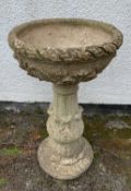 COMPOSITION STONE GARDEN URN, moulded foliate decoration to circular bow and pedestal column,