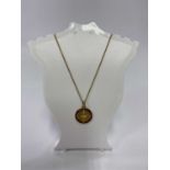 DIAMOND & RUBY SET CIRCULAR PENDANT on a nine carat gold fine link necklace, the pendant unmarked