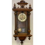 CIRCA 1900 VIENNA TYPE WALNUT CASED WALL CLOCK having Roman numerals set against enamel, before a