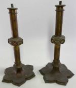 VICTORIAN BRASS GOTHIC STYLE CANDLESTICKS, A PAIR - lacking screw on sconces, lacquered brass with