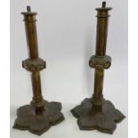 VICTORIAN BRASS GOTHIC STYLE CANDLESTICKS, A PAIR - lacking screw on sconces, lacquered brass with