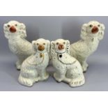 STAFFORDSHIRE POTTERY DOGS, TWO PAIRS - both in white with gilt highlighting, 31cm and 23.5cm