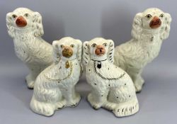 STAFFORDSHIRE POTTERY DOGS, TWO PAIRS - both in white with gilt highlighting, 31cm and 23.5cm