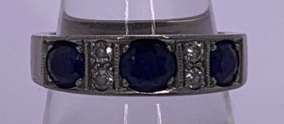 AN 18CT WHITE GOLD DRESS RING - having 3 well sized sapphires with 4 intervening tiny diamonds, 8.