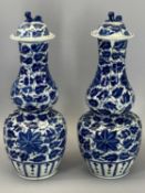 LATE 19th CENTURY CHINESE DOUBLE GOURD BLUE & WHITE VASES, with lids, a pair, 29cms H