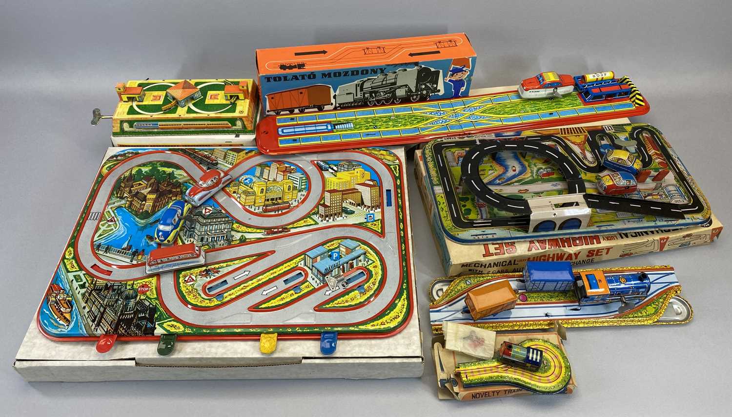 TIN PLATE CLOCKWORK CAR & RAILWAY PLAY SETS (6) - all boxed, mid to late 20th Century to include