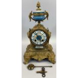 JAPY FRERES CO FRENCH GILT ORMOLU & PORCELAIN MANTEL CLOCK - having an urn finial and side masks