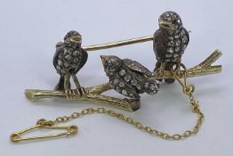 A YELLOW METAL (NO MARKS VISIBLE) BAR BROOCH - in the form of a branch, having three standing