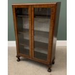 VINTAGE WALNUT CHINA DISPLAY CABINET having twin glazed doors and interior shelving, on ball and