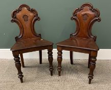 VICTORIAN MAHOGANY HALL CHAIRS, a pair, with carved scroll work backs, on turned front supports,