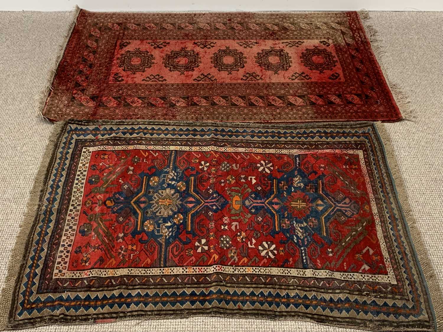 EASTERN TYPE WOOLLEN RUGS (2), red ground with repeating central patterns and multiple bordered