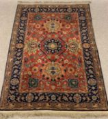 MIDDLE EASTERN STYLE WOOLLEN RUG, red ground with repeating central pattern and blue ground double