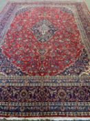LARGE EASTERN TYPE WOOLLEN CARPET, red and blue ground and multi-bordered with traditional style