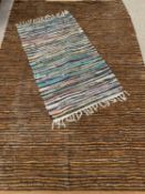 TWO VINTAGE RUGS to include an Indian rubber, leather and fabric mix, 240 x 162cms and a stitched