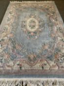 "KAYAM" LABEL CHINESE WASHED WOOLLEN RUG, blue and cream ground with traditional floral pattern, 303