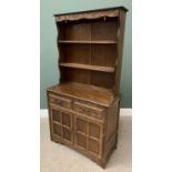 REPRODUCTION OAK DRESSER having carved detail to the two shelf rack over a base section with two