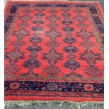 LARGE WOOLLEN TASSEL ENDED RUG, red ground with traditional pattern and wide bordered edging, 280