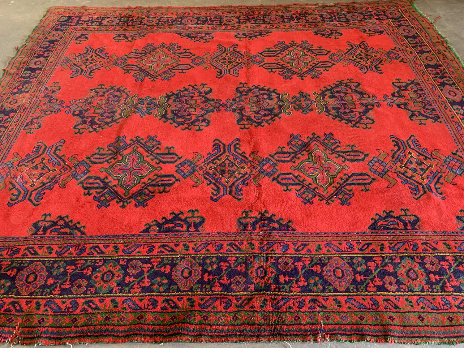 EASTERN STYLE WOOLLEN RUG, red ground with blue border and central repeating pattern, 341 x 294cms - Image 2 of 3