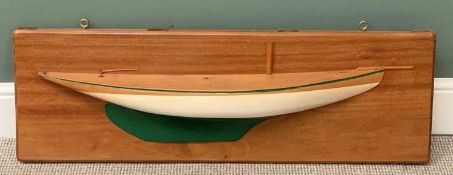 WALL MOUNTED HALF HULL WOODEN MODEL OF A YACHT, on a mahogany board, 35cms H, 107cms W, 13cms D