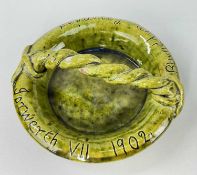 EWENNY POTTERY DISH having a loop rope-twist handle, green mottled glaze incised 'Iorwerth VII 1902,