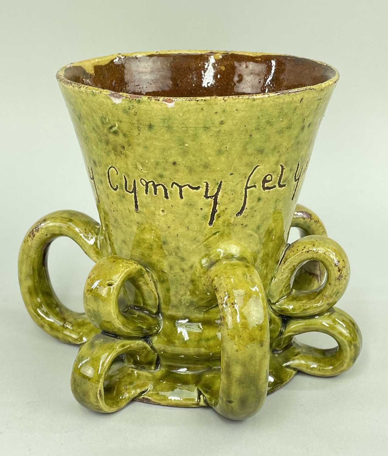 EWENNY POTTERY TYG in green glaze, and having three double loop handles and three single loop
