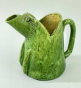 EWENNY POTTERY ZOOMORPHIC JUG IN THE FORM OF A CARICATURE PIG, in a mottled green glaze, 18.5cms