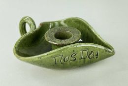 EWENNY POTTERY CHAMBERSTICK in mottled green glaze, of leaf-form with loop handle, sgraffito